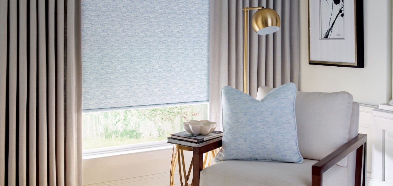 A cozy reading nook with an upholstered chair and a side table.